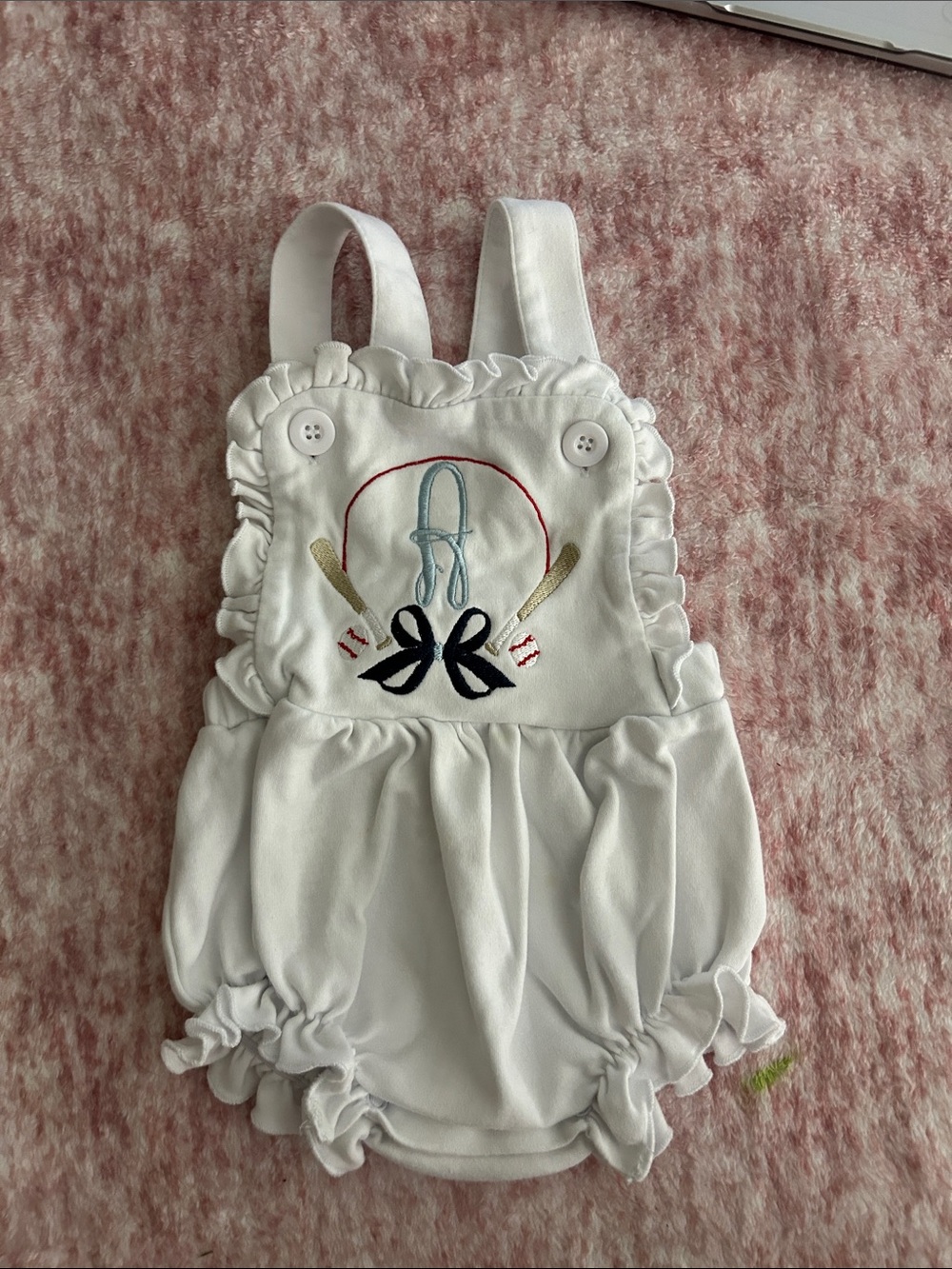 A monogrammed White Ruffle Baseball romper